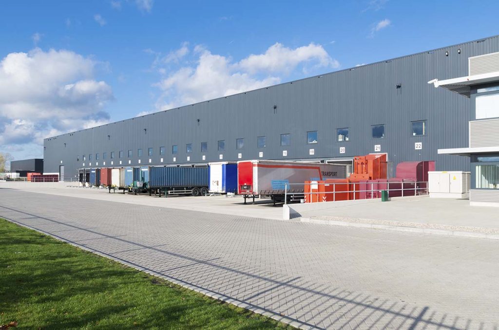 exterior,of,a,large,warehouse,with,loading,docks,and,several